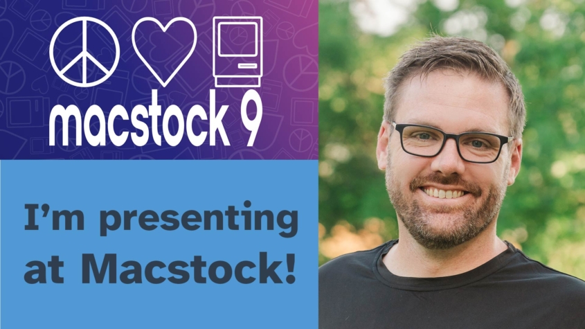 Mike, a man with glasses and a beard wearing a black shirt, smiles at the camera against a blurred green outdoor background. To his left is the Macstock 9 logo featuring peace, heart, and computer icons, with text announcing "I'm presenting at Macstock!" on a blue background.