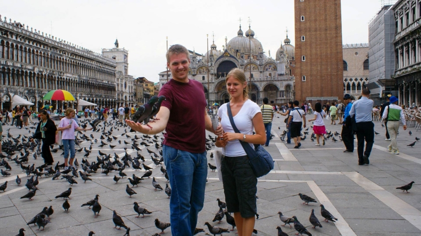 Feeding pigeons in Venice's St. Mark's Square during the 2007 Italy trip, with the Basilica and Campanile visible in the background